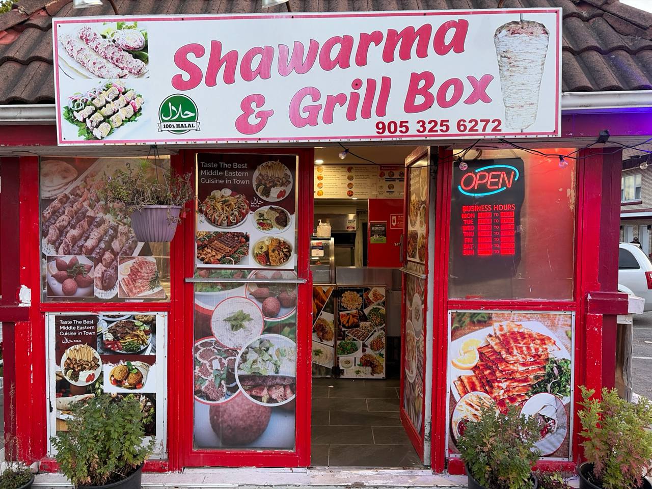 Shawarma and Grill Box storefront on Lundy's Lane at dusk with the open sign lit